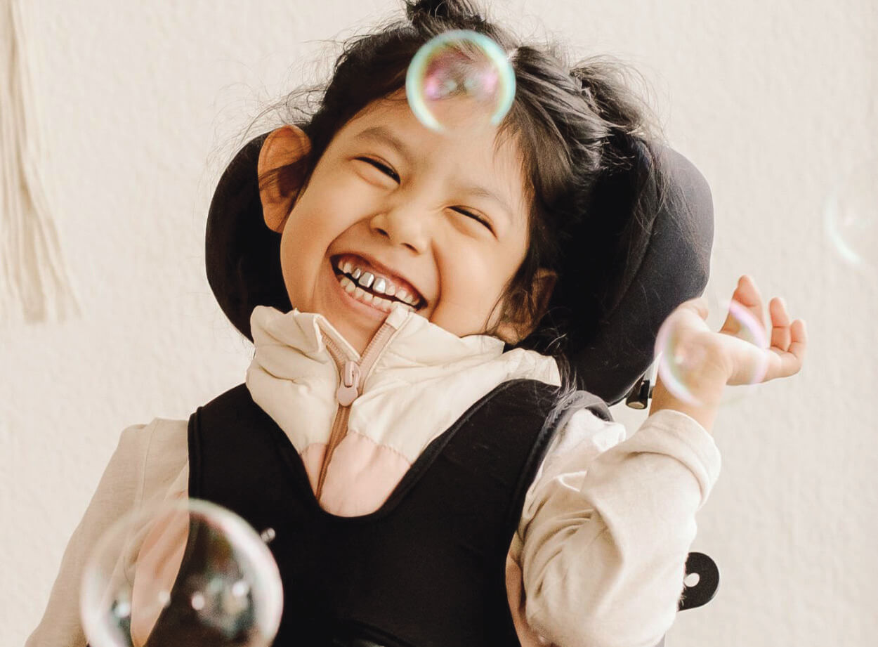 Happy child with bubbles in supportive care environment