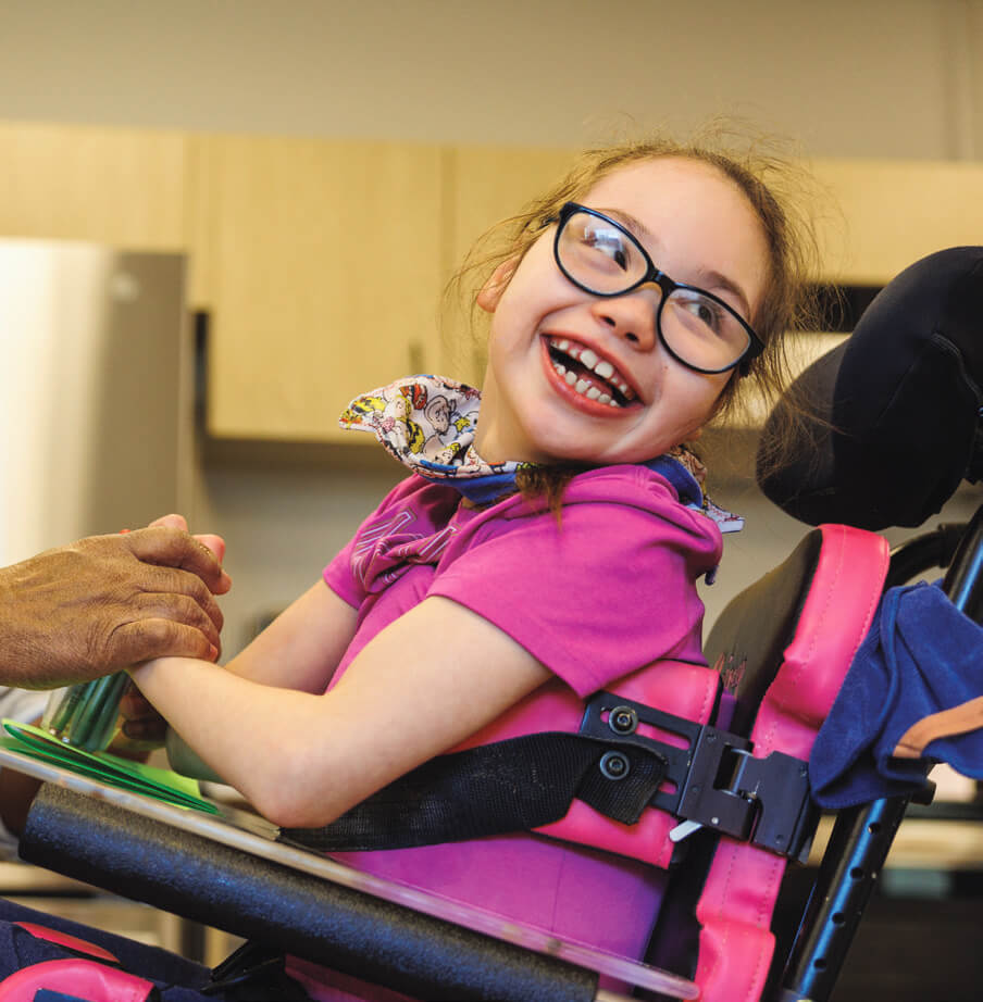 Child smiling in wheelchair